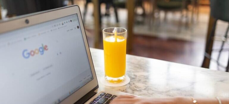 person using Google while drinking juice