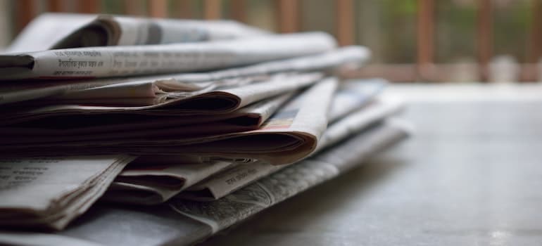 stacked newspapers on a desk