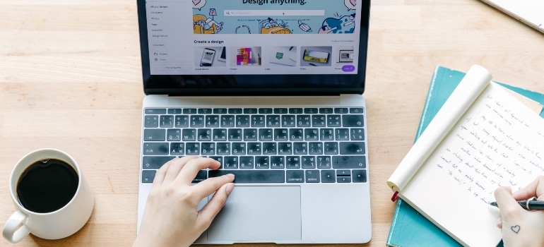 Person with a laptop and notebook