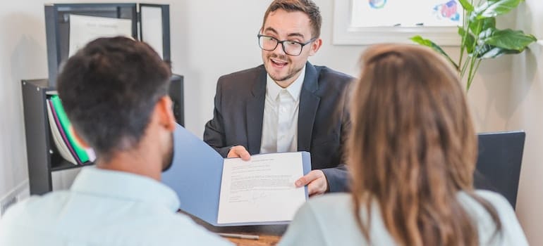 moving company representative showing clients a contract