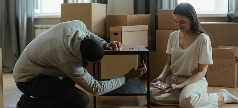 Parents packing for a move after contacting moving companies marketing to millennial parents.