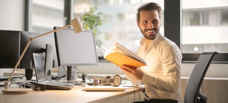 A person in the office reading about digital marketing basics for new moving companies