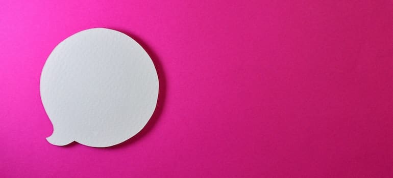 A chatbox symbol on a pink surface. 