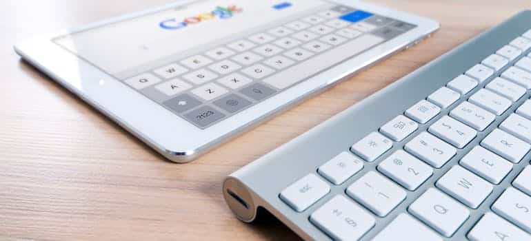 A computer keyboard and a tablet