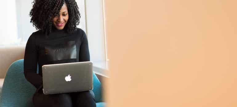 woman reading an email and smiling