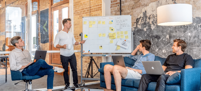 A man discussing organic SEO vs PPC with his team