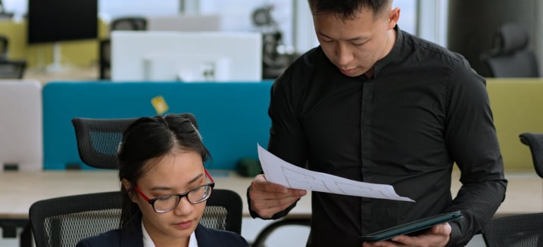 two people looking at papers