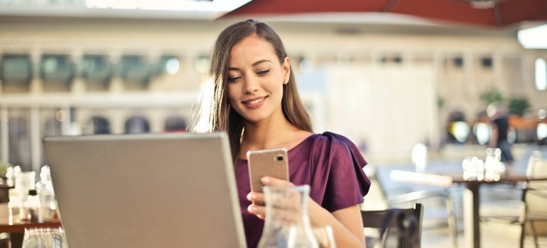 Woman smiling and reading strategies for moving companies to outshine competitors