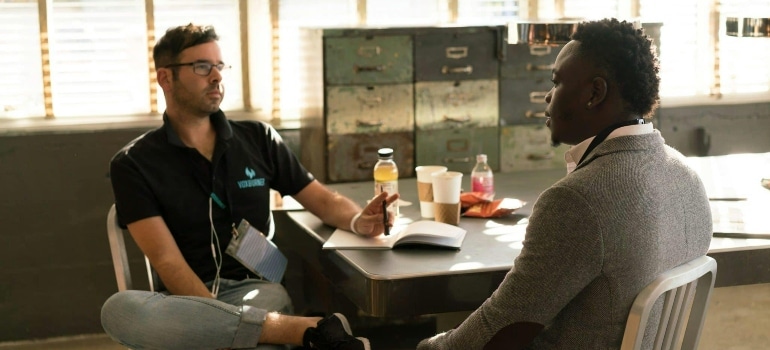 Two coworkers chatting in the office.