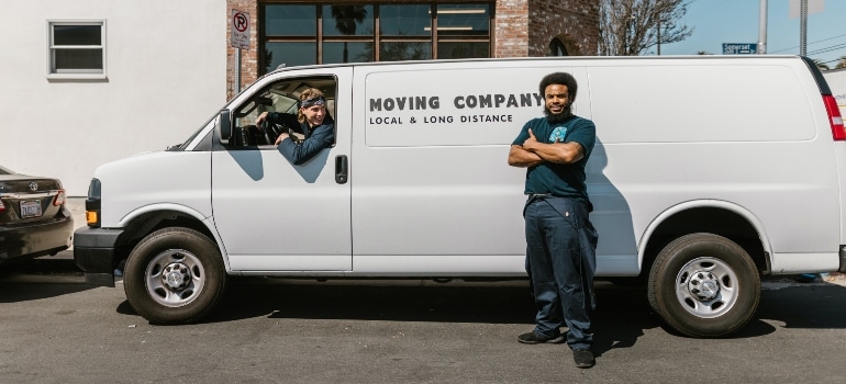 A man leaning on a moving van