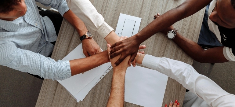People joining hands after a successful meeting. 