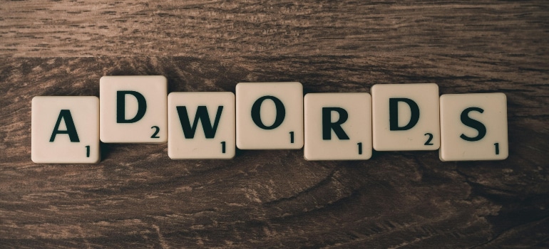 Scrabble tiles spelling out 'ADWORDS'