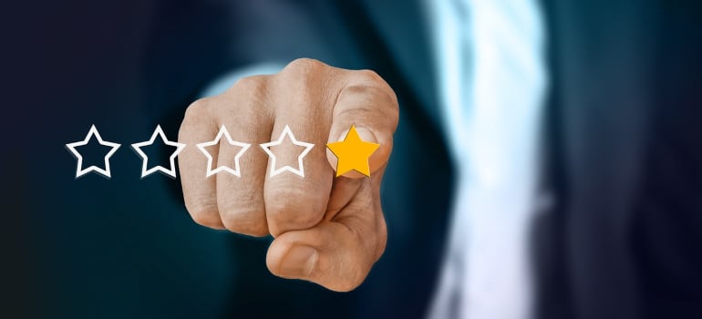 hand pointing at a 5 star rating system