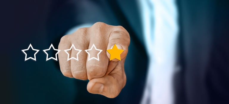 A hand selecting a star rating.