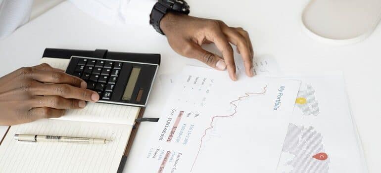 Person calulating a budget for a business.