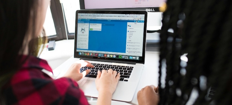 A woman researching how to win more repeat business on her laptop