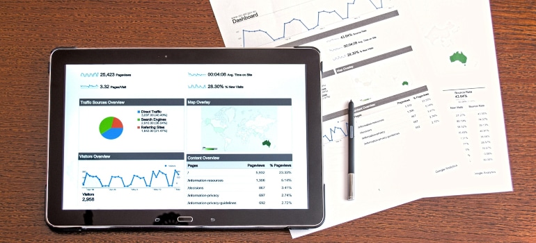 Tablet displaying analytics data and graphs, highlighting the rise of mobile storage pods through data analysis and performance tracking.