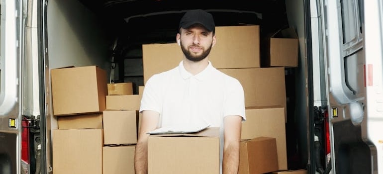 A moving company employee holding a box