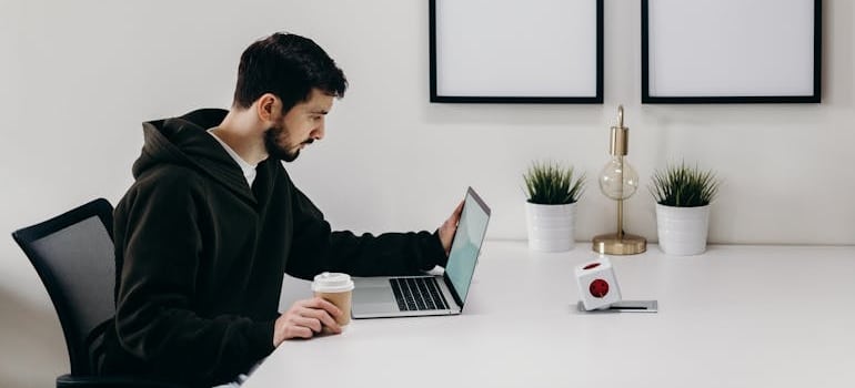 A person using a laptop to look for moving services