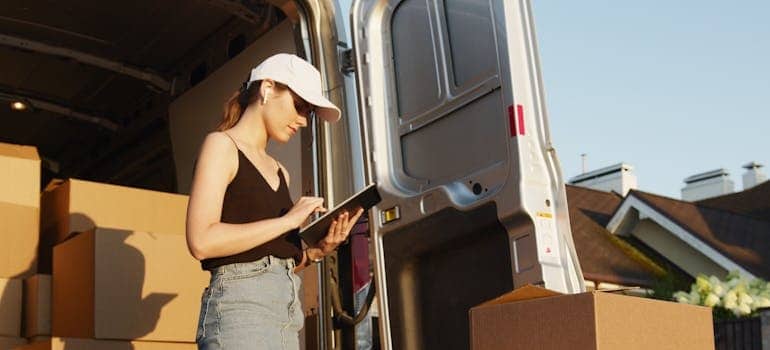 An employee of a moving company using a tablet