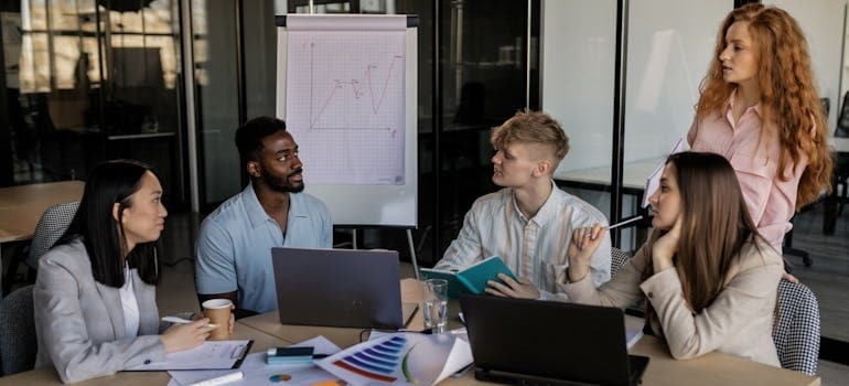 A marketing team discussing tips for moving companies battling bigger competitors