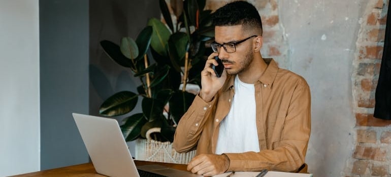 A confused person using a laptop