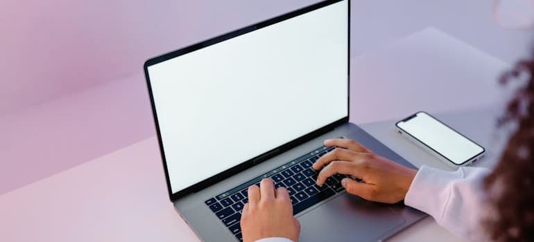 A person using a laptop to read about ways to fight back against disloyal competition