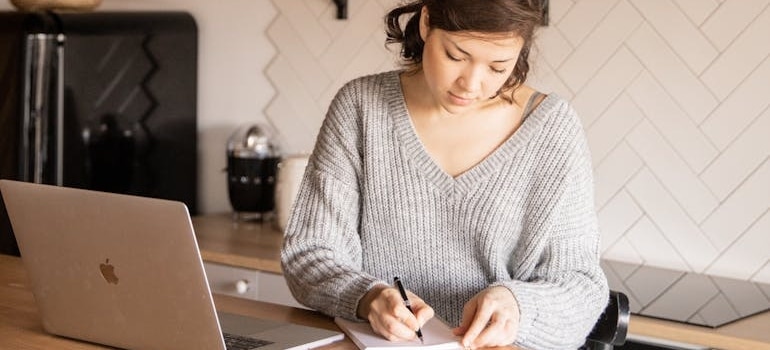 A person doing research and writing down tactics to rank for estimate related searches