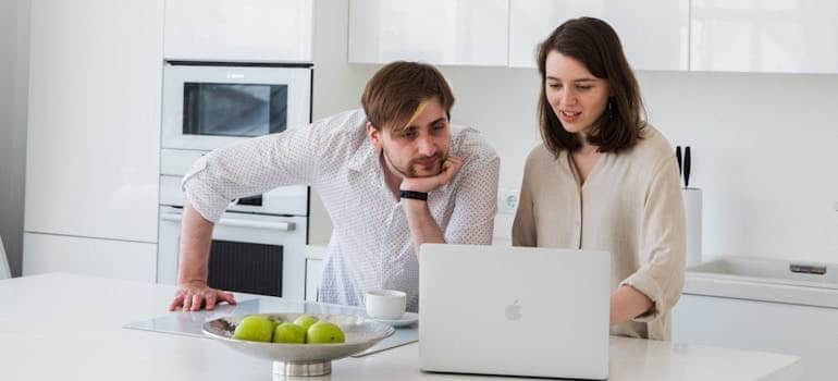 A couple looking for movers online