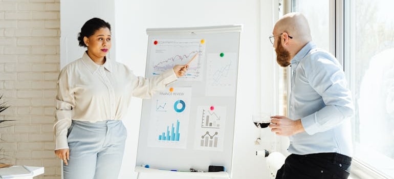 Two colleagues making the marketing agency evaluation for moving companies