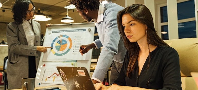 A person using a laptop to look for tactics to rank for estimate related searches