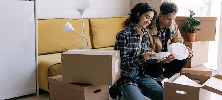 Two people packing their items and getting ready for a relocation