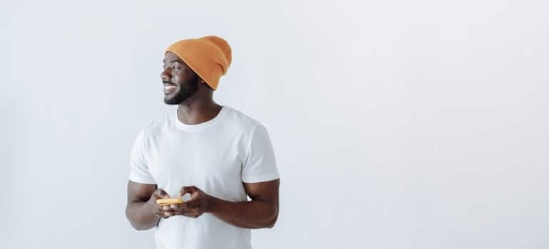 A person smiling while using their mobile phone
