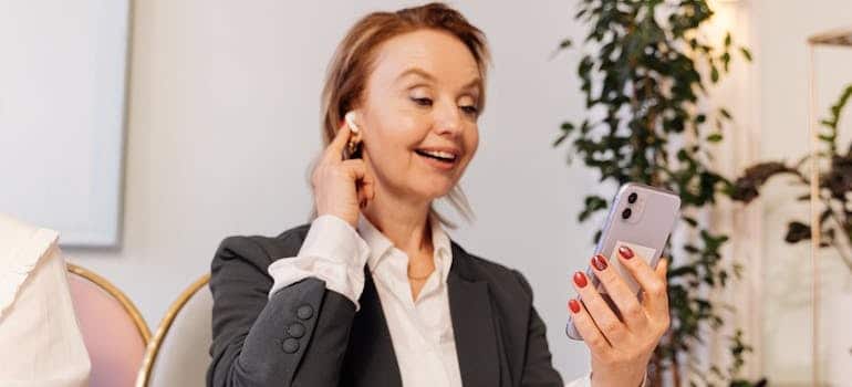 A person calling to book a service from a moving company that knows how to attract high-end clients and bigger jobs