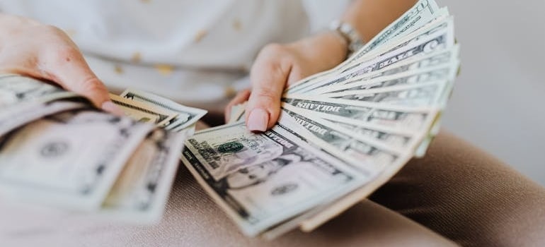 A person holding dollar bills